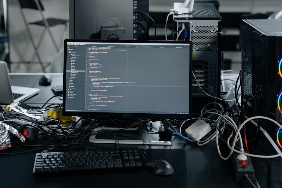 A computer screen displaying a code editor with HTML and CSS code visible on the black background. The code includes tags like <html>, <head>, and <meta>, with syntax highlighting in colors such as bl